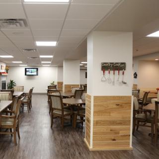 A cozy and well-lit dining area featuring wooden furniture and an inviting atmosphere.