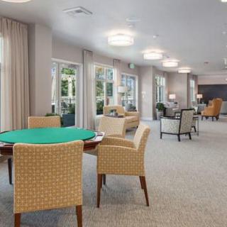 Spacious lounge area with comfortable seating and large windows.