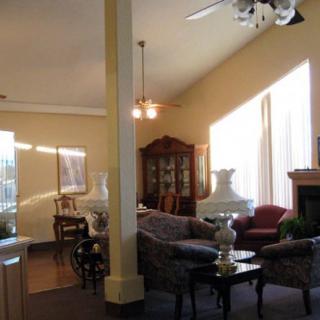A cozy living room with elegant furniture and warm sunlight streaming through the windows.