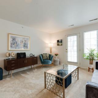 A modern living room featuring a stylish armchair, a sleek coffee table, and decorative artwork on the walls.