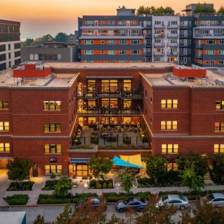 A vibrant urban apartment complex at sunset.