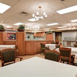 An interior view of a dining area with tables, chairs, and elegant wooden decor.