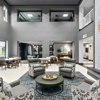 A spacious and modern living room with comfortable seating and stylish decor.