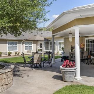 A well-maintained outdoor patio with seating and landscaping.