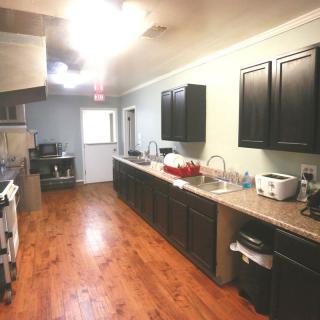 A spacious kitchen with modern cabinetry and appliances.