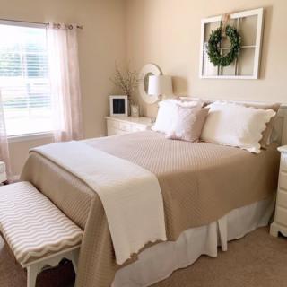 A cozy bedroom with neutral tones and elegant decor.
