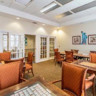 A spacious community room with tables and chairs for gatherings.