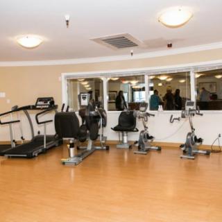 A gym room featuring various exercise equipment including treadmills and stationary bikes.