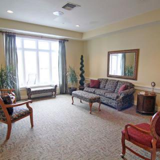 A cozy living room with comfortable seating and large windows.