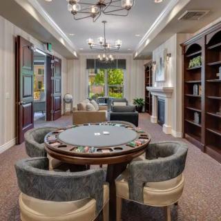 Luxurious lounge with a poker table and elegant decor.