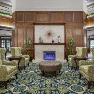 A luxurious hotel lobby with elegant seating arrangements and a fireplace.