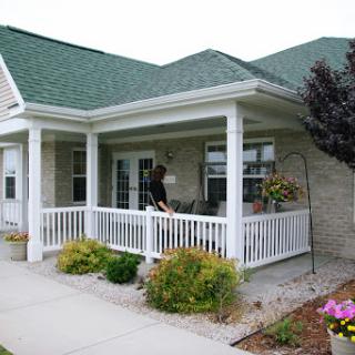 A charming house with a welcoming front porch and well-maintained garden.