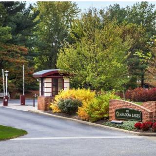 Entrance to a gated community with autumn foliage.