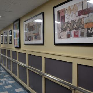 A well-decorated hallway featuring framed artworks that enhance the environment.