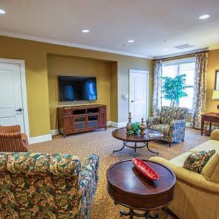 A cozy living room with stylish furniture and a TV setup.