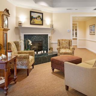 A cozy living room with a fireplace and traditional furnishings.