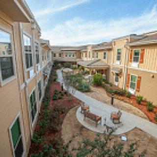A view of a residential complex with a central courtyard and pathways.
