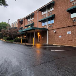 A brick building entrance captured on a rainy day.