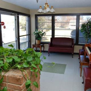 A bright and inviting waiting room with comfortable seating and lush greenery.