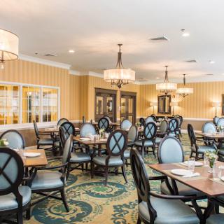 A stylishly designed dining room with elegant furniture and soft lighting, perfect for social gatherings.