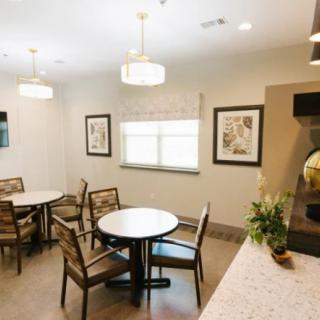 A cozy indoor dining area with tables, chairs, and decorative elements.