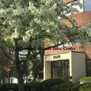 A medical care center surrounded by greenery.