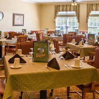 A well-organized dining area with neatly arranged tables and chairs, ready for guests.