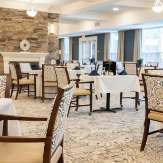 An elegant dining room with neatly arranged tables and chairs, featuring a sophisticated interior design.