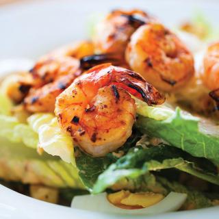 Grilled shrimp served on a fresh bed of lettuce.