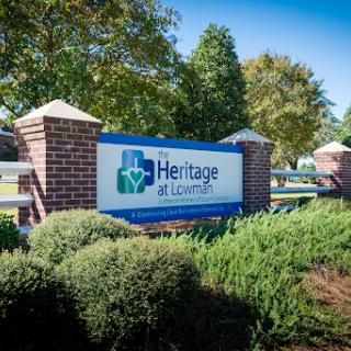Welcome to Heritage at Lousiville - a community space surrounded by lush greenery.