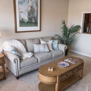 A cozy living room with a comfortable sofa, stylish coffee table, and decorative artwork.