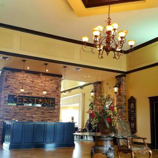 A beautifully designed hotel lobby featuring a stylish chandelier and warm lighting.