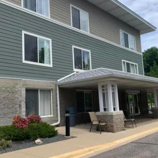 A modern three-story building with a landscaped entrance.