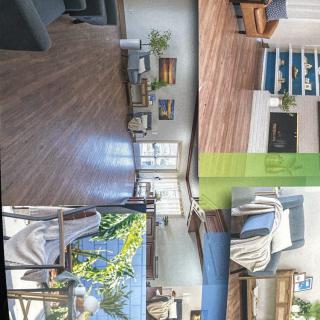 A stylish and cozy living room with wood flooring, a fireplace, and plenty of natural light.