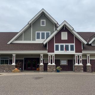 A modern suburban house with a garage and unique architectural features.