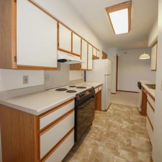 A modern kitchen with ample cabinet space and standard appliances.