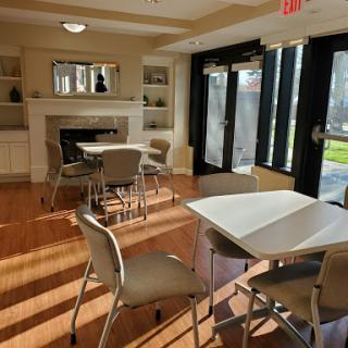 A cozy lounge area featuring modern furniture and ample natural light.