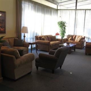 A cozy lobby area with comfortable sofas and armchairs, offering a welcoming space for visitors.
