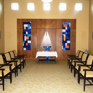 A serene waiting area featuring comfortable chairs and decorative artwork.