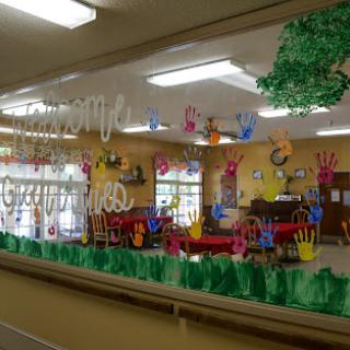 A vibrant classroom filled with children's artwork and creative decorations.