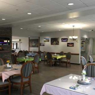 A cozy dining area with neatly arranged tables and chairs, featuring a casual and welcoming atmosphere.