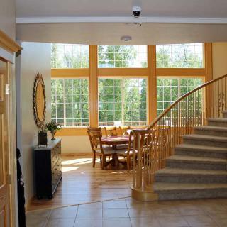 Spacious interior with a dining area and large windows allowing natural light.