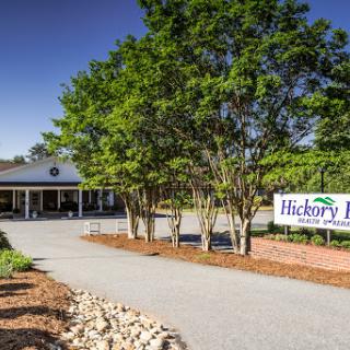 Entrance to Hickory Lane, showcasing a welcoming landscape and clear signage.