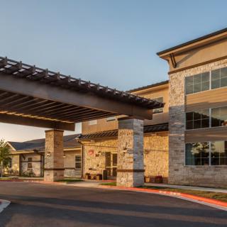 Modern commercial building with a covered entrance.