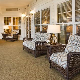A cozy lounge area with rattan furniture and warm lighting.