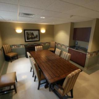 A well-furnished conference room with a long table and several chairs, suitable for meetings and discussions.