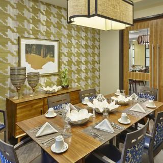A modern dining room with a beautifully set table and stylish decor.