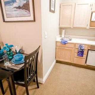 A cozy kitchen and dining area with a neatly arranged table setting.