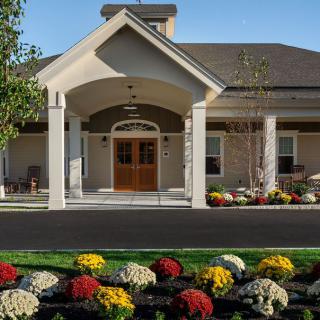 A well-maintained building entrance with colorful landscaping.