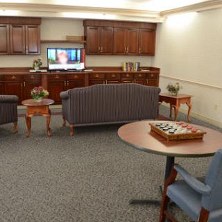 A cozy waiting room featuring comfortable seating and a television.